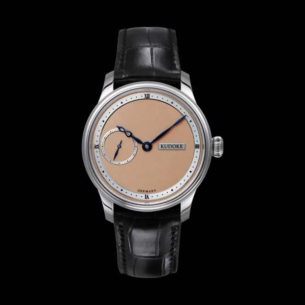 Kudoke 1 – Salmon dial front view with small seconds at 9 o’clock and blued steel infinity hour hand
