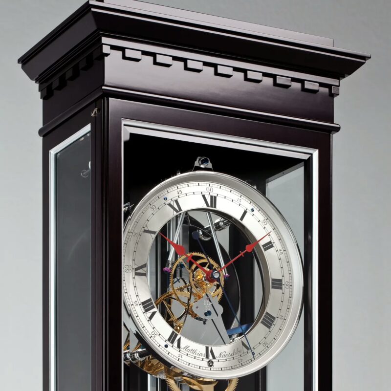 Clock dial close-up showing sterling silver chapter ring and Roman numerals