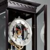 Clock with open door revealing mechanical movement and glass case