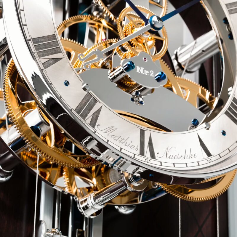 NL 126 Longcase Clock dial close-up with sterling silver chapter ring and visible gear train