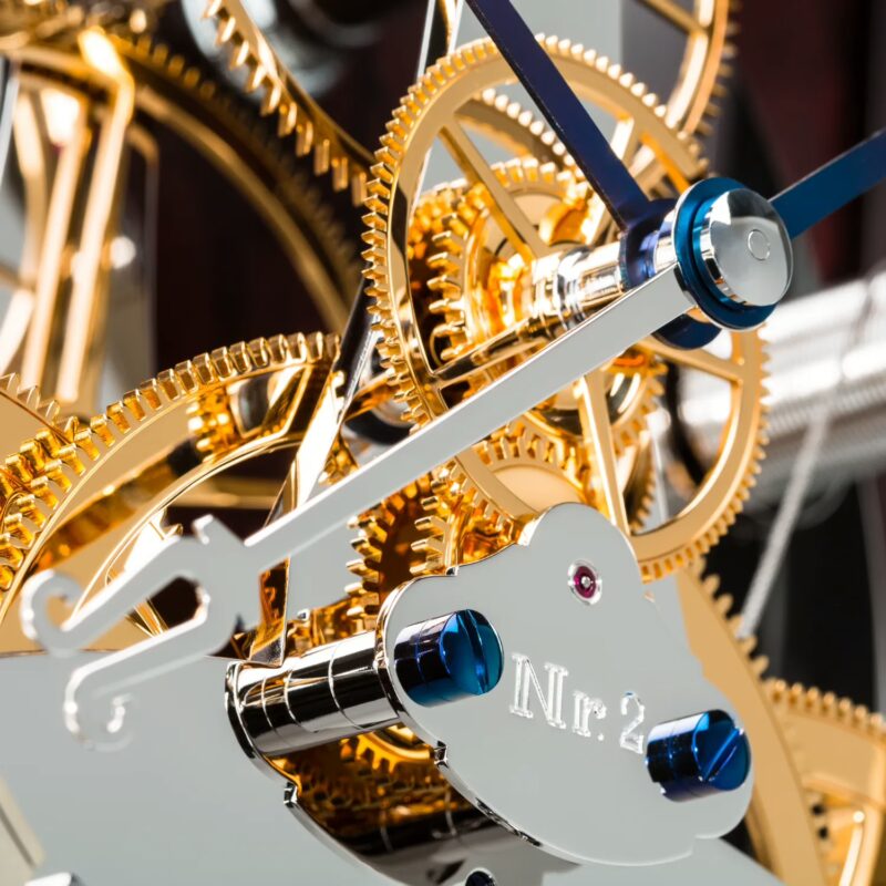 Mechanical movement detail showing brass gears and blued screws