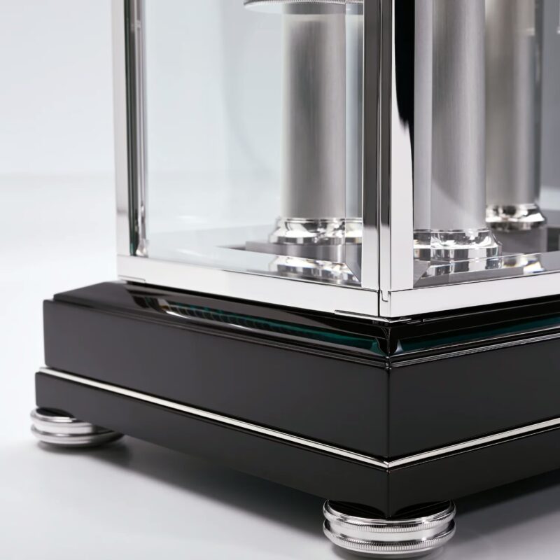 Glass canopy base with high-gloss black finish, metal inlays, and precision-crafted support feet