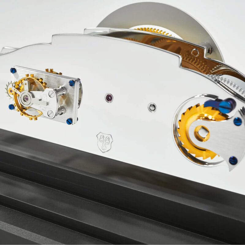 Rear view of handcrafted clock movement with polished plates and fine finishing details